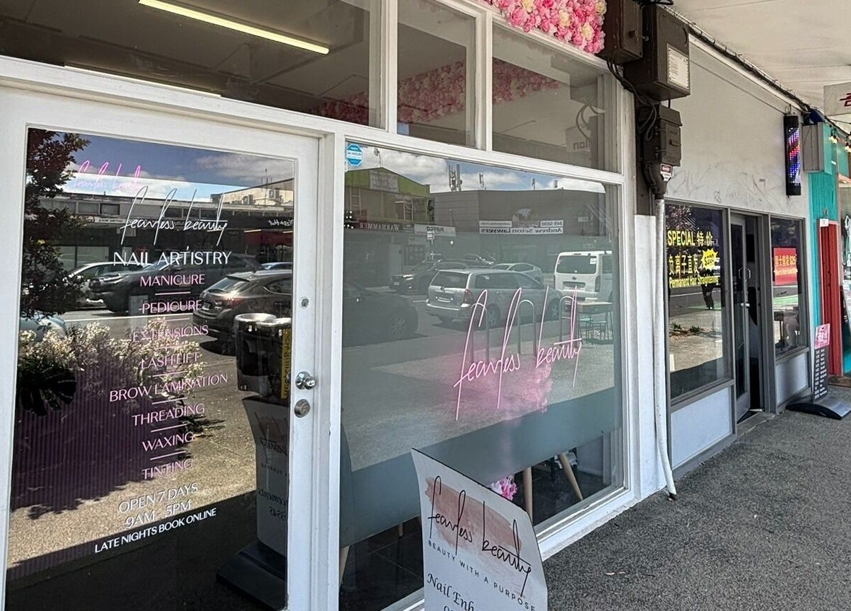 Entrance of Fearless Beauty in Auckland, NZ showcasing elegant window design and signage.