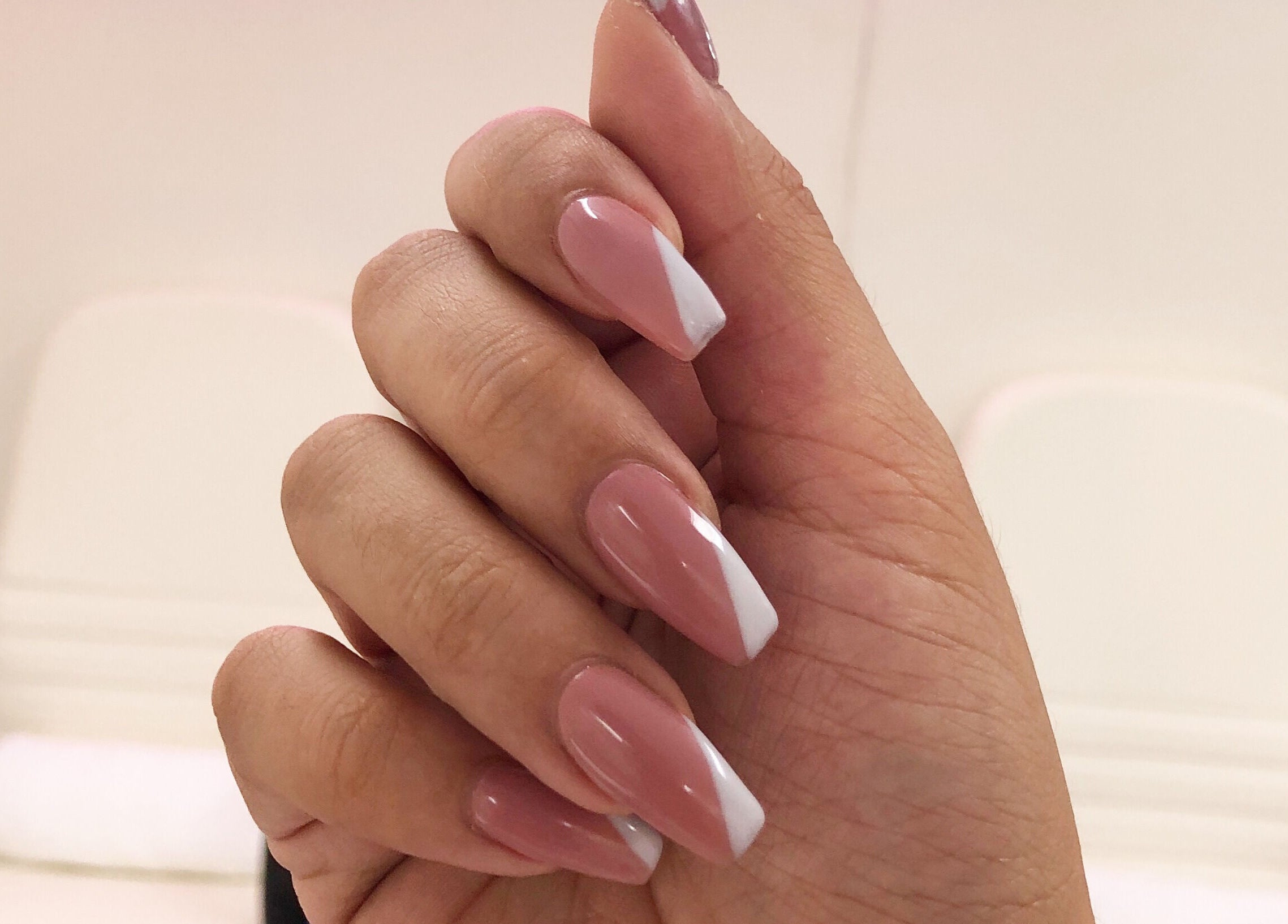 Stylish pink and white manicure at Fearless Beauty in Auckland, Auckland, NZ. Perfect for chic elegance.