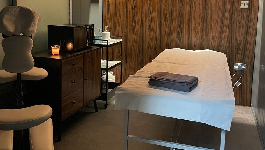 Relaxing treatment room at Baliga Ayurveda & Skin Clinic, London, England, GB, showcasing a massage table and soft lighting.