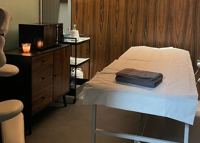 Relaxing treatment room at Baliga Ayurveda & Skin Clinic, London, England, GB, showcasing a massage table and soft lighting.