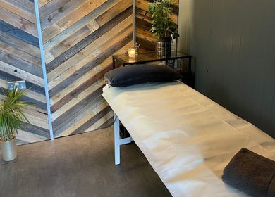 Cozy treatment room at Baliga Ayurveda & Skin Clinic in London, England, GB with soft lighting and minimalist decor.