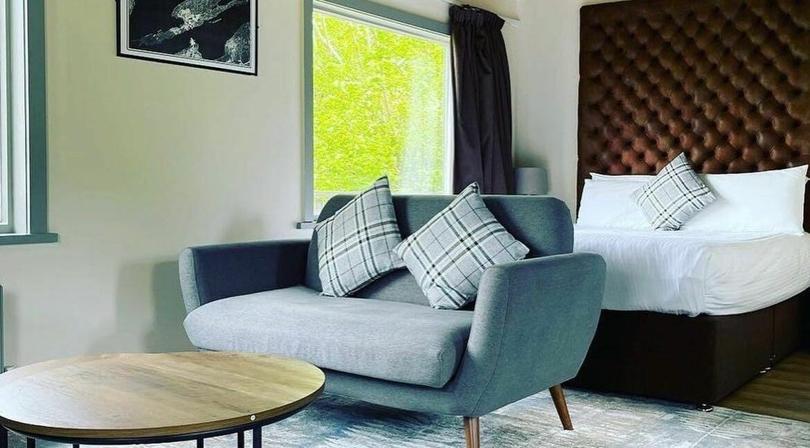 Luxurious room at Lusty Beg Island, Enniskillen, Northern Ireland, GB with stylish sofa and plush bedding.