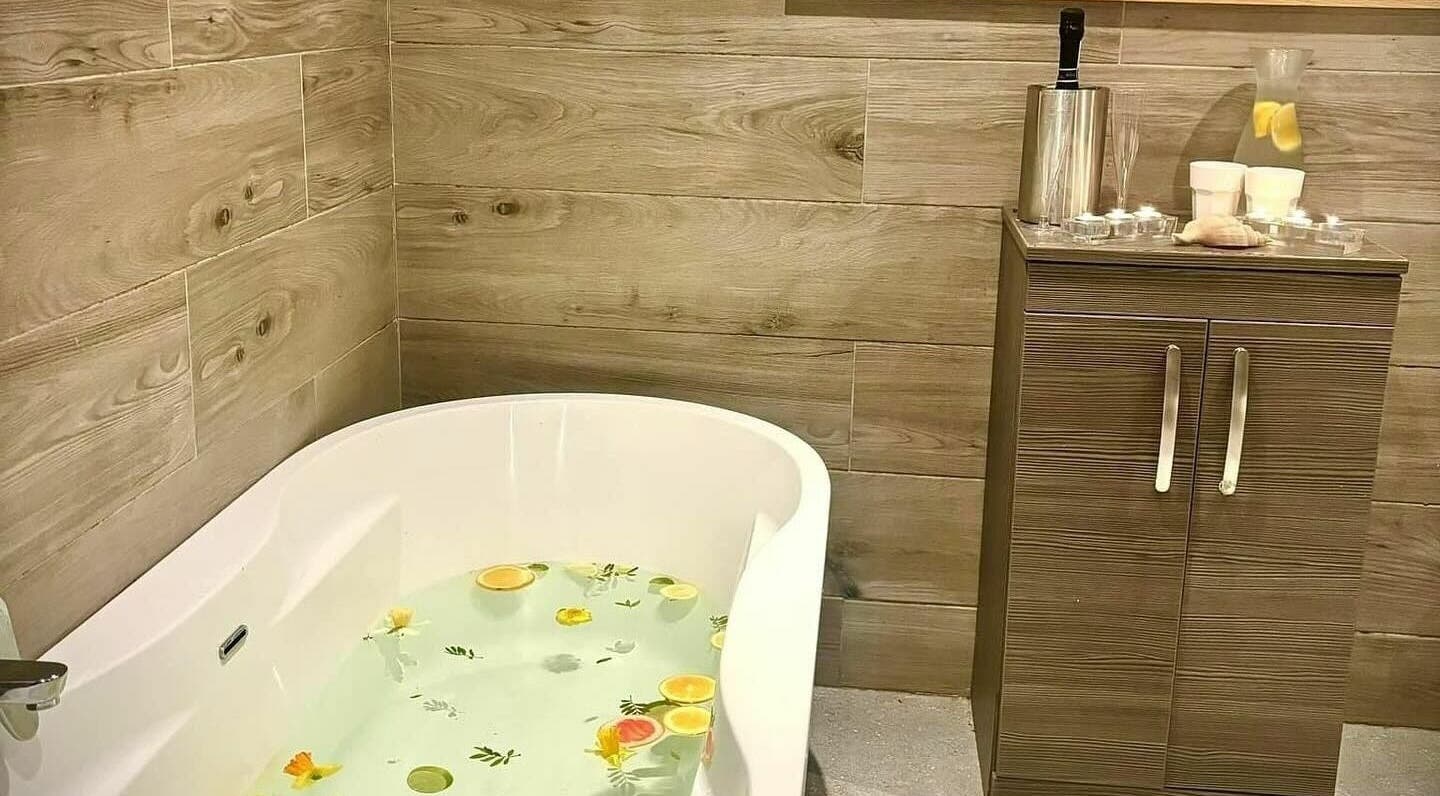 Luxurious bathtub with citrus and flowers at Lusty Beg Island, Enniskillen, Northern Ireland, GB.