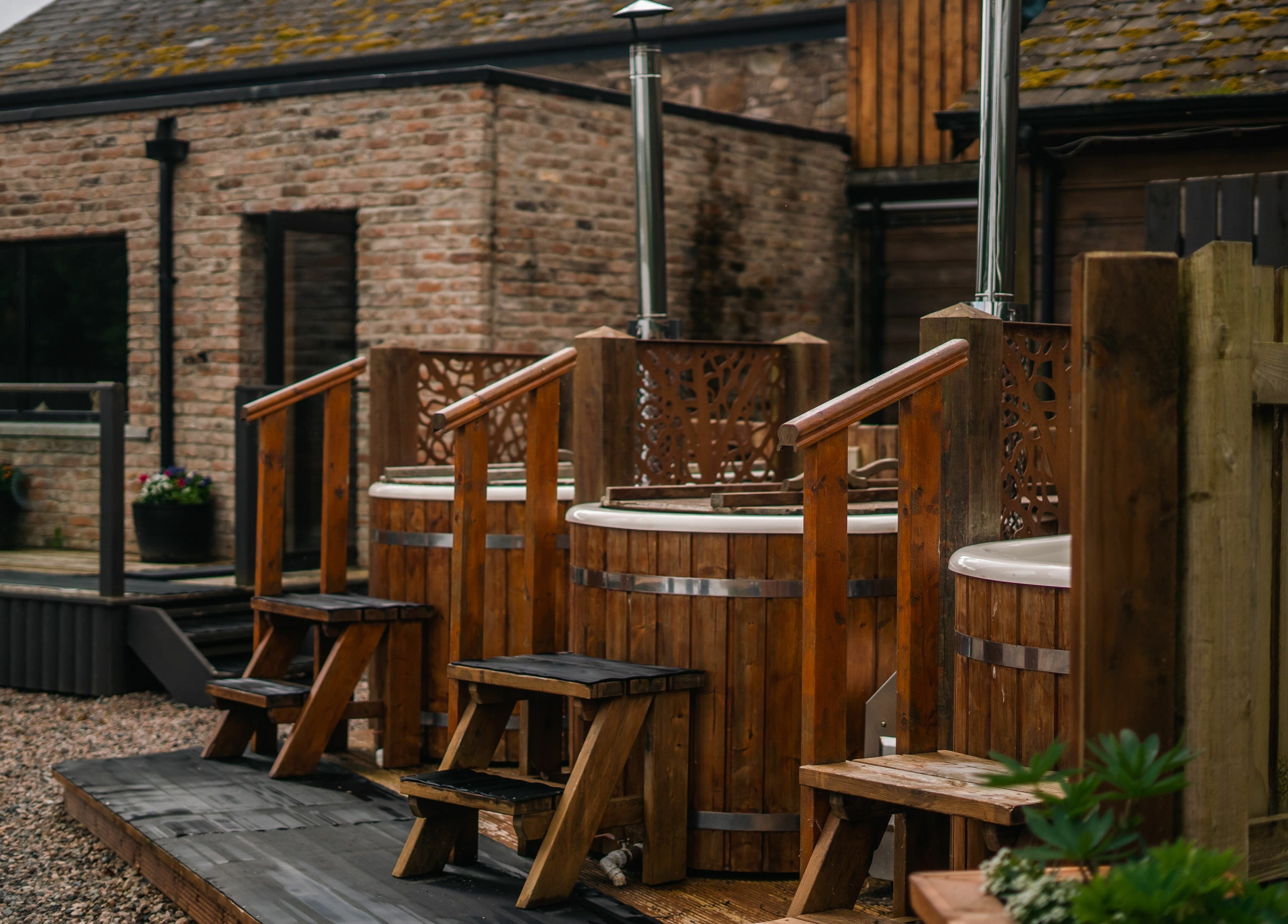 Outdoor hot tubs at Lusty Beg Island, Enniskillen, Northern Ireland, GB offer a tranquil spa experience.