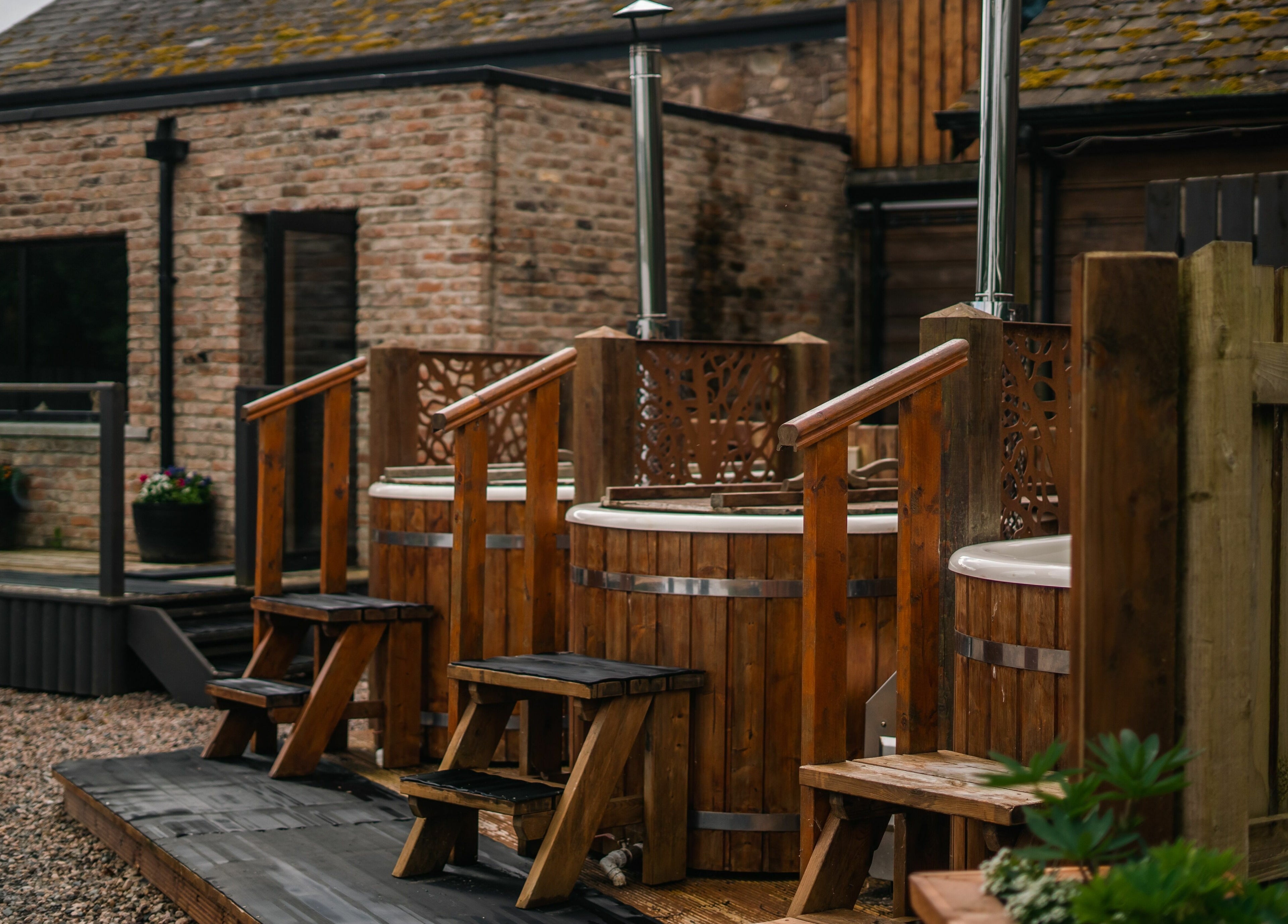 Outdoor hot tubs at Lusty Beg Island, Enniskillen, Northern Ireland, GB offer a tranquil spa experience.