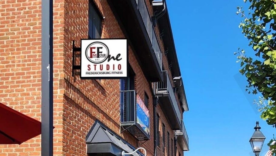 Exterior of 541 William St., Fredericksburg, Virginia, US, featuring a fitness studio sign and brick facade.