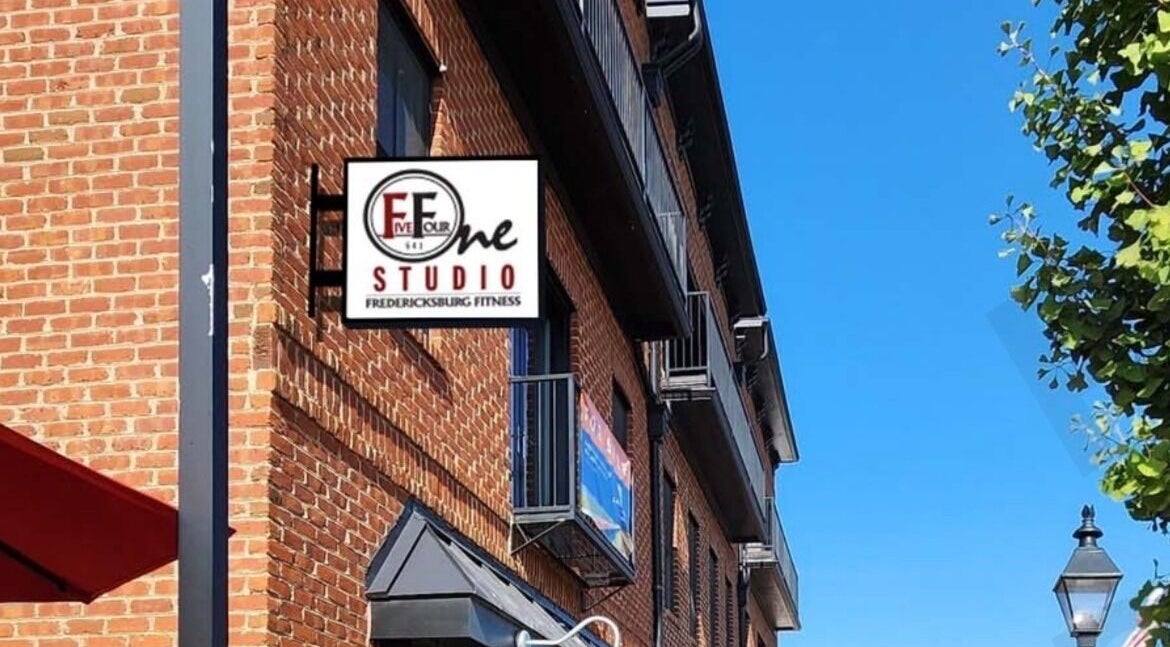 Exterior of 541 William St., Fredericksburg, Virginia, US, featuring a fitness studio sign and brick facade.