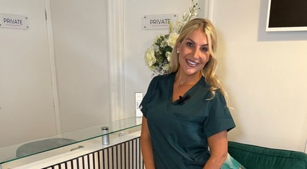 Staff member at Rosalyn’s Medical Clinic, Wakefield, England, GB, smiling at the reception.