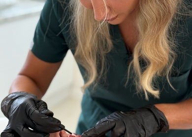 Professional at Rosalyn’s Medical Clinic, Wakefield, England, GB, performing a detailed procedure with precision.