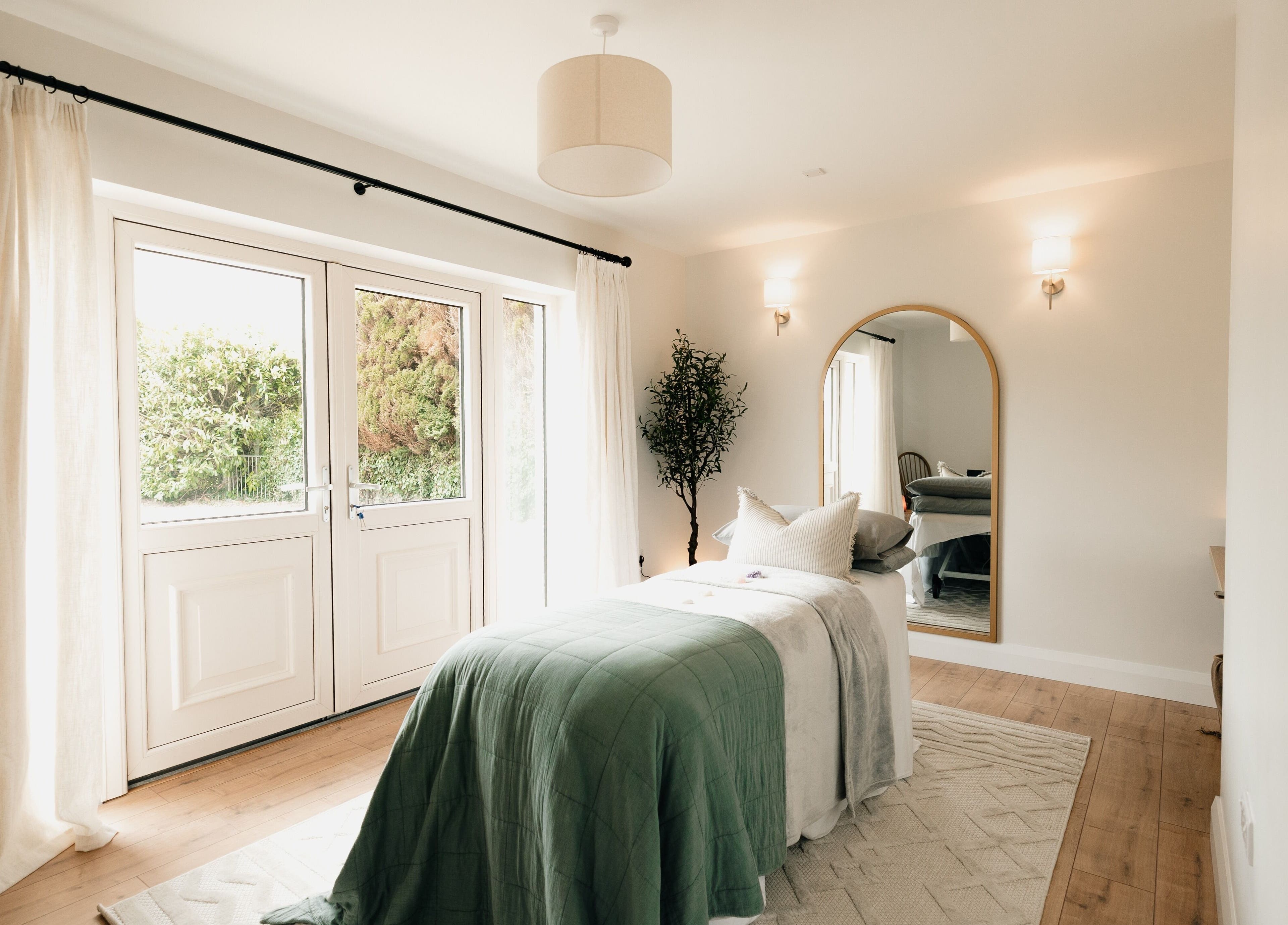 Serene treatment room at Sãno Wellness | Amy O Mara, Lisnagry, IE, featuring elegant decor and natural light.