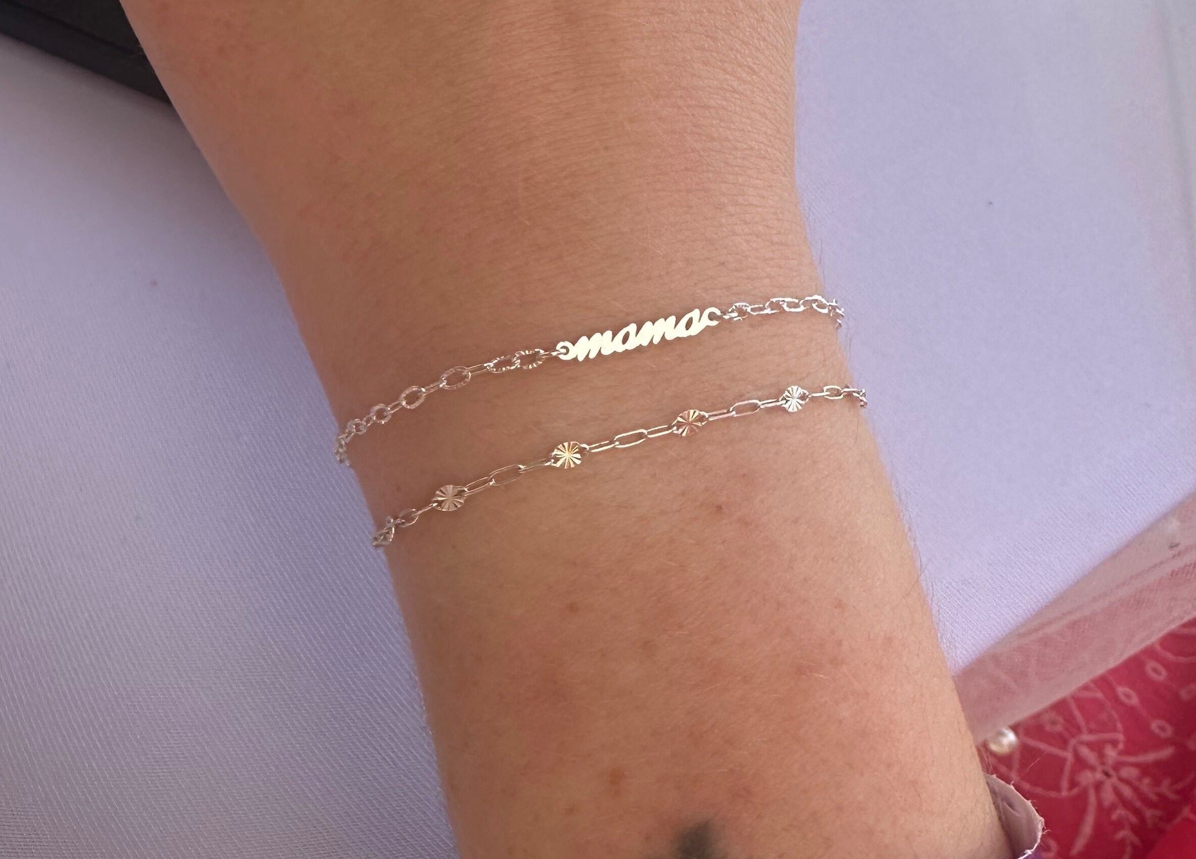 Delicate bracelets on wrist at Sanctuary Eleven-Daisy Chains, Royal Leamington Spa, England, GB.