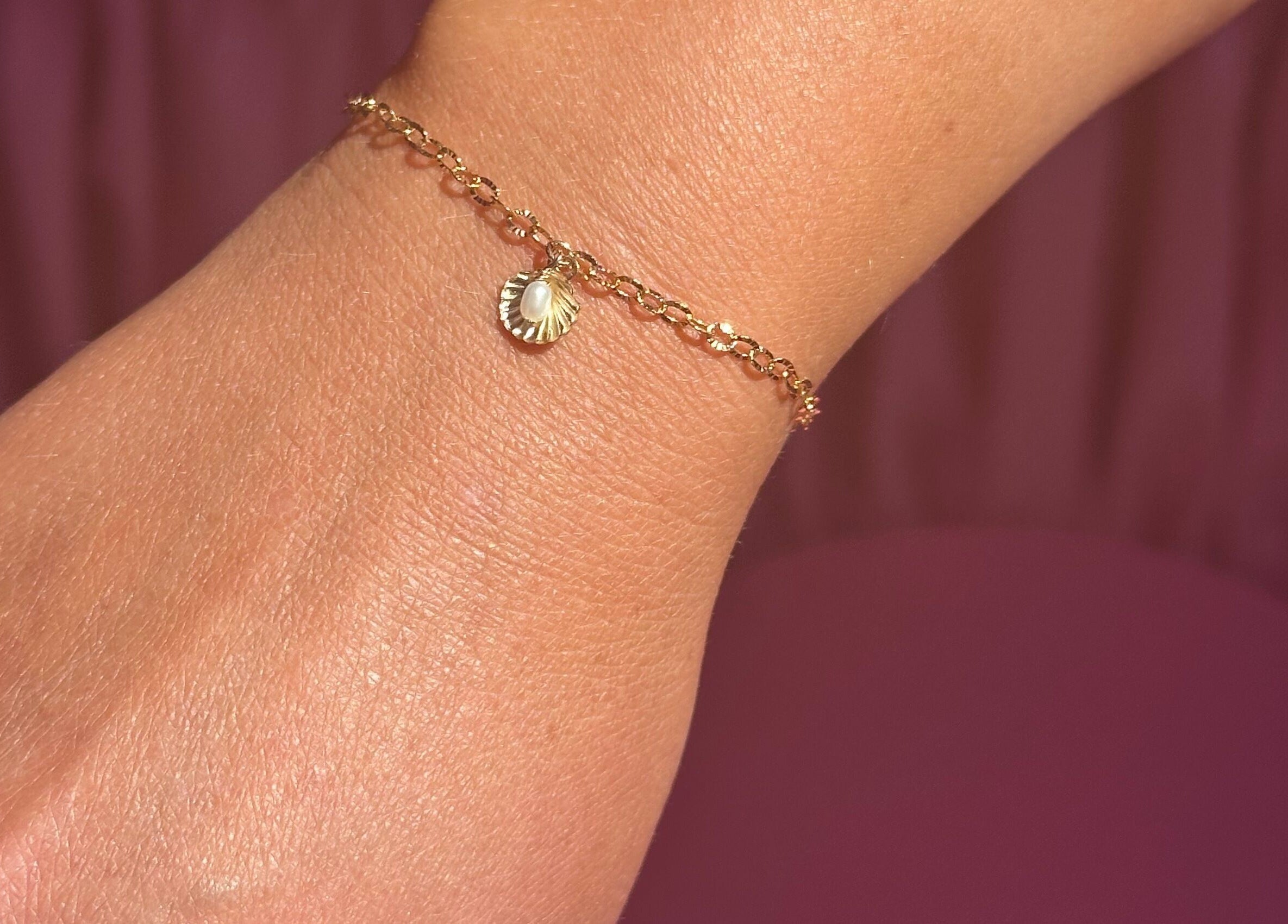 Delicate gold bracelet with charm at Sanctuary Eleven-Daisy Chains, Royal Leamington Spa, England, GB.