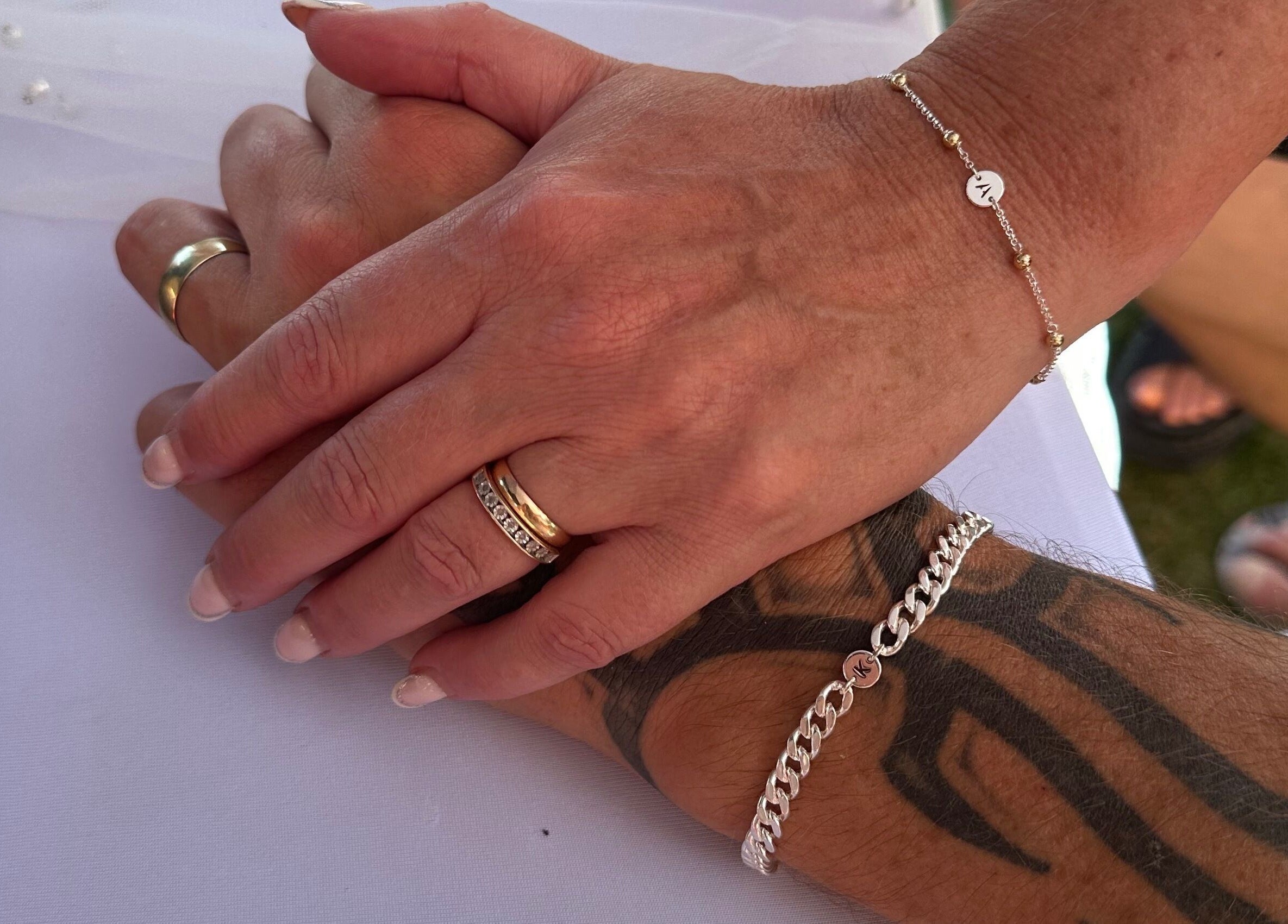 Close-up of hands holding, showcasing jewelry at Sanctuary Eleven-Daisy Chains, Royal Leamington Spa, England, GB.