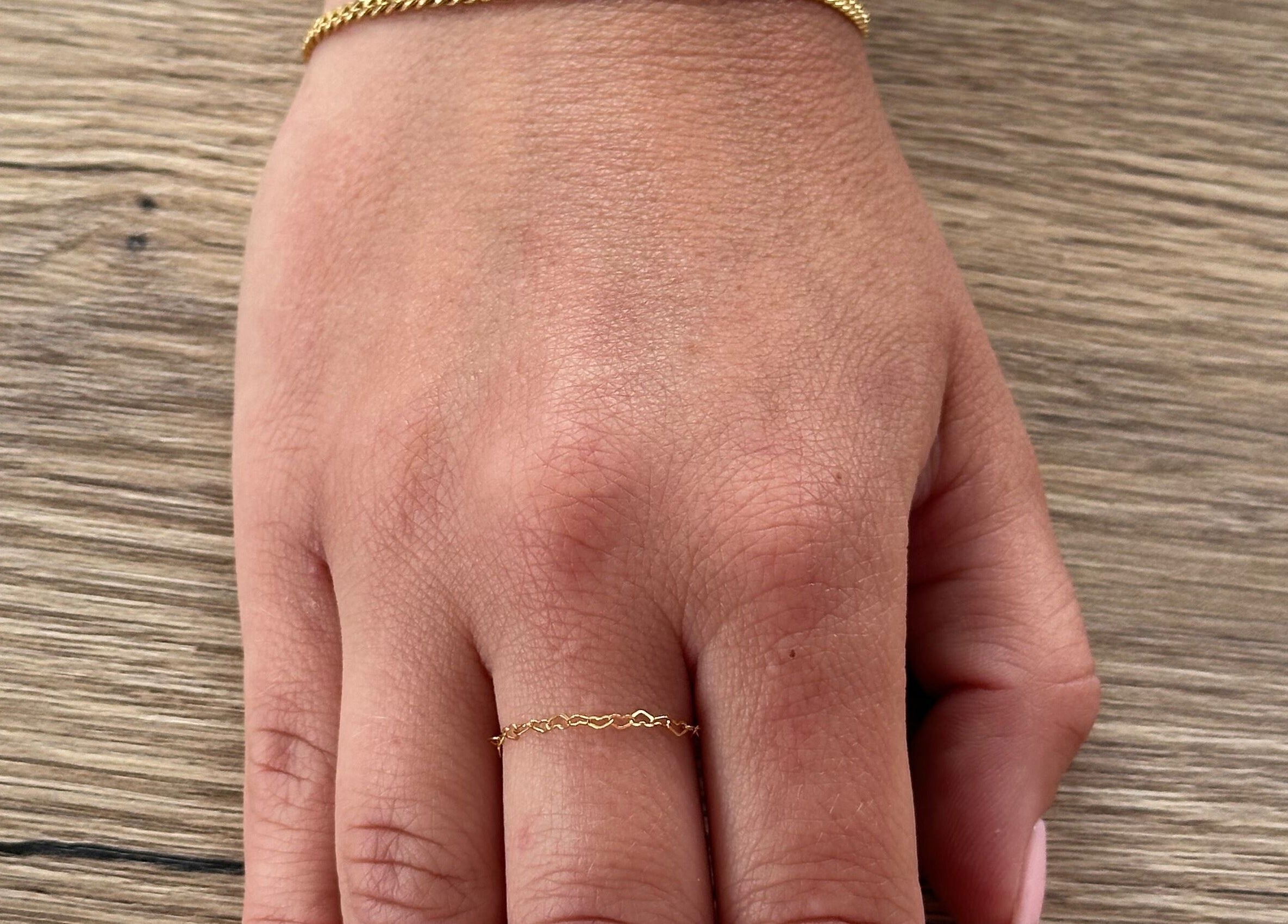 Dainty gold ring on a hand at Sanctuary Eleven-Daisy Chains, Royal Leamington Spa, England, GB.
