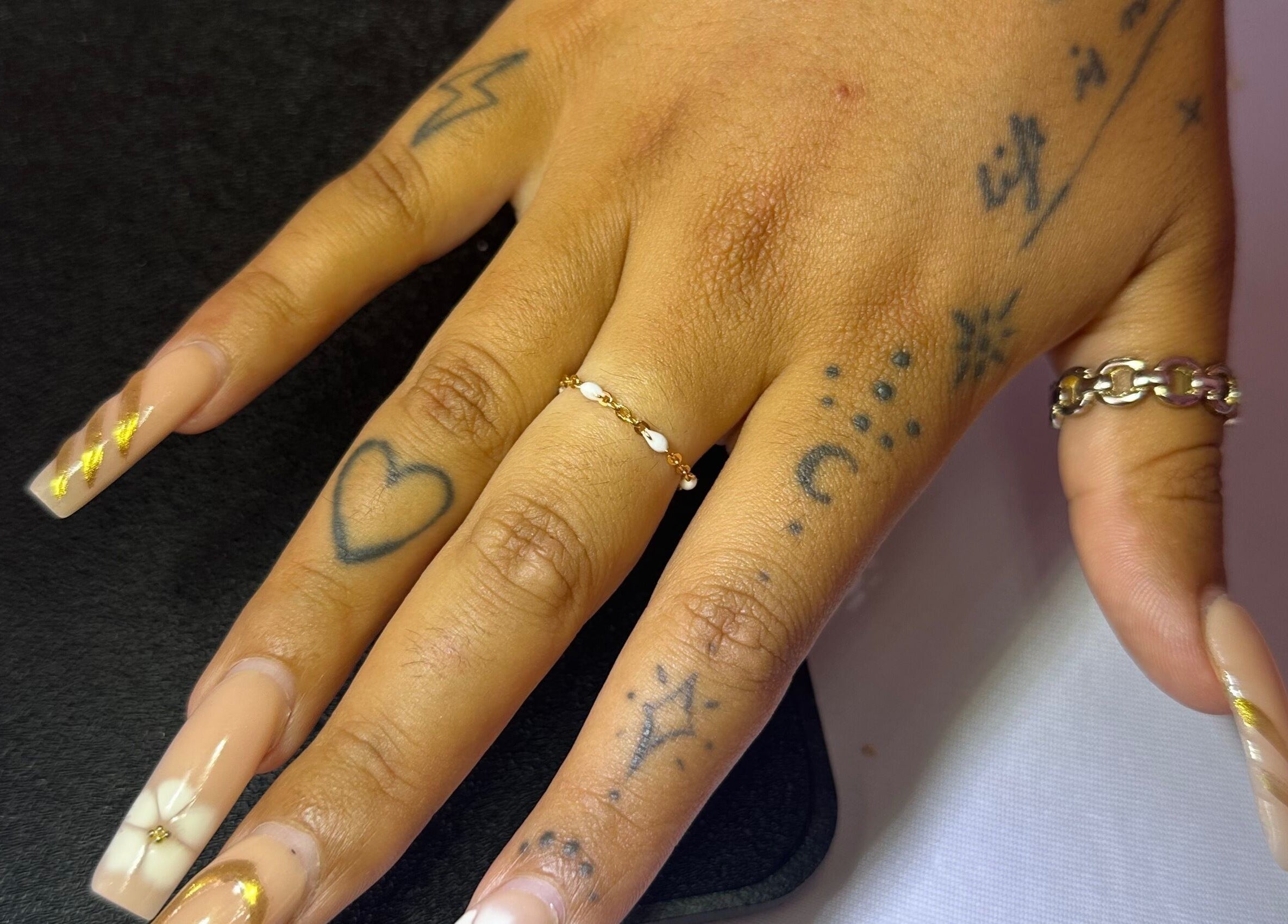 Hand with artistic nail design at Sanctuary Eleven-Daisy Chains, Royal Leamington Spa, England, GB.