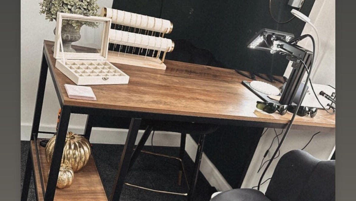 Elegant beauty workspace at Daisy Chains, Willoughby, England, GB with wooden desk and stylish decor.