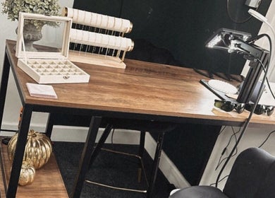 Elegant beauty workspace at Daisy Chains, Willoughby, England, GB with wooden desk and stylish decor.