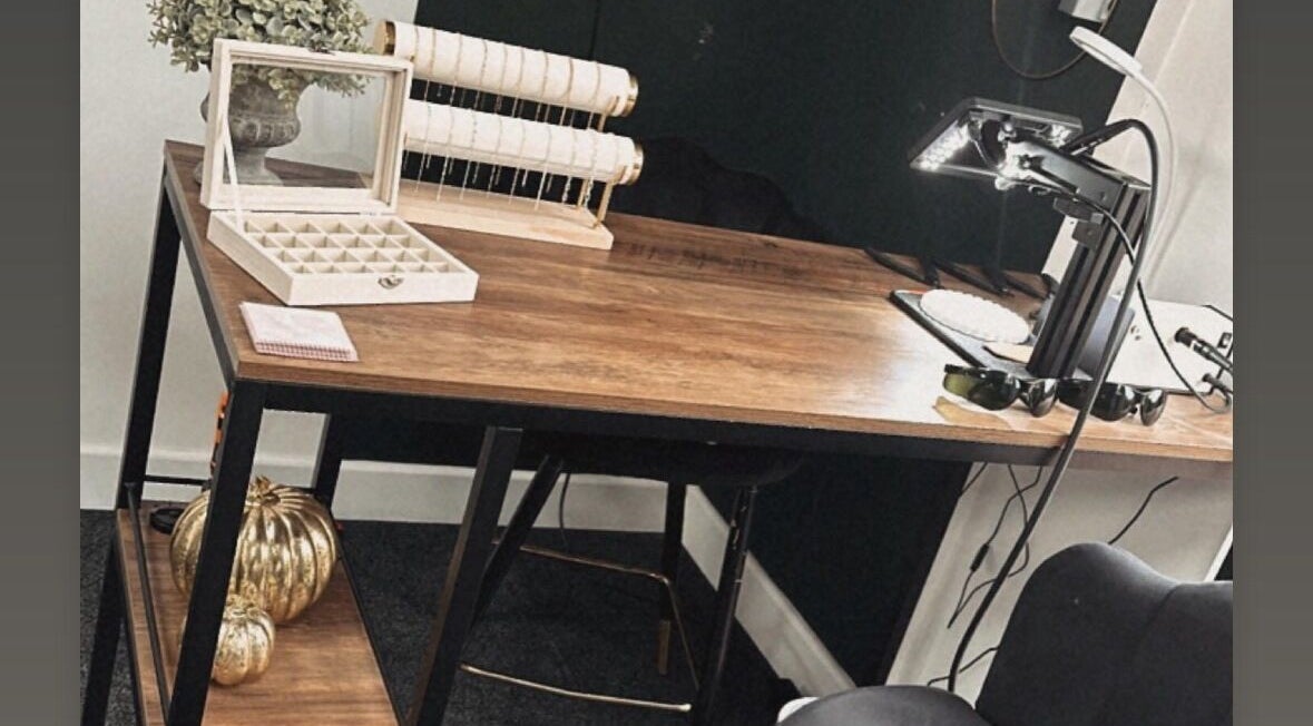 Elegant beauty workspace at Daisy Chains, Willoughby, England, GB with wooden desk and stylish decor.
