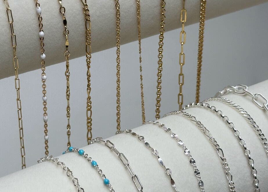 Variety of gold and silver chains elegantly displayed at Daisy Chains, Willoughby, England, GB.