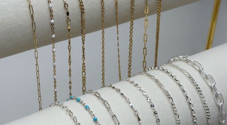Variety of gold and silver chains elegantly displayed at Daisy Chains, Willoughby, England, GB.