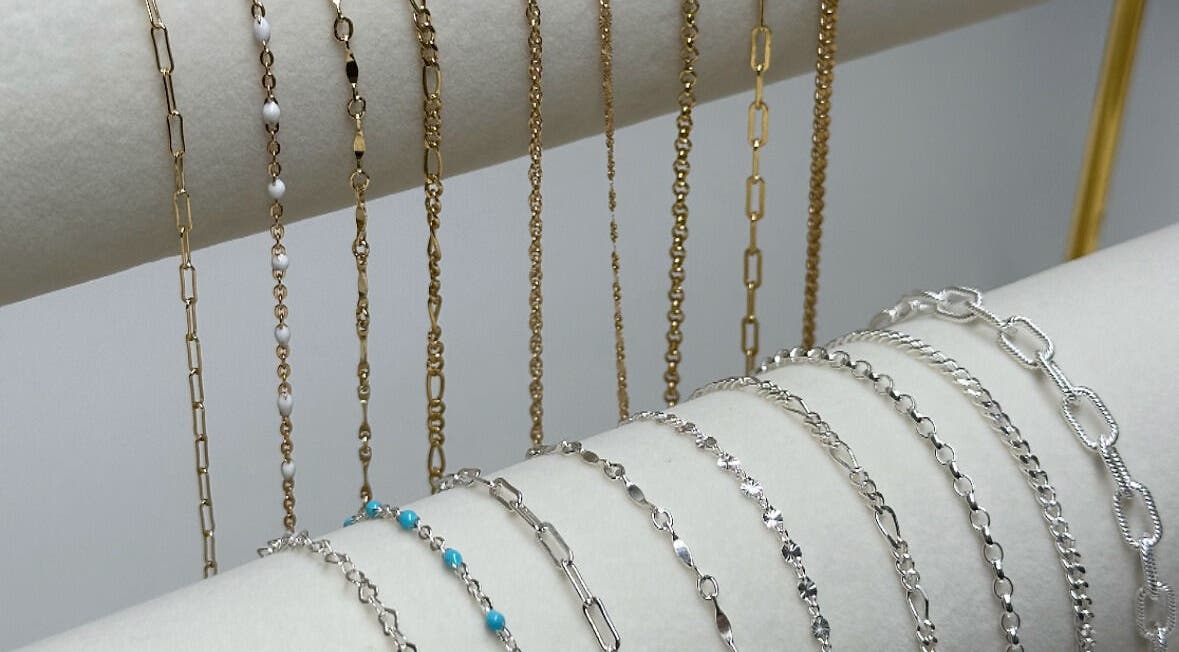 Variety of gold and silver chains elegantly displayed at Daisy Chains, Willoughby, England, GB.