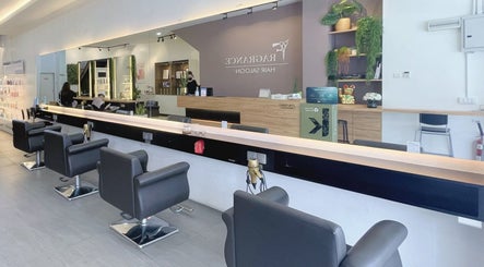 Stylish interior of Fragrance Hair Saloon in Cheras, Selangor, MY showcasing modern black salon chairs.