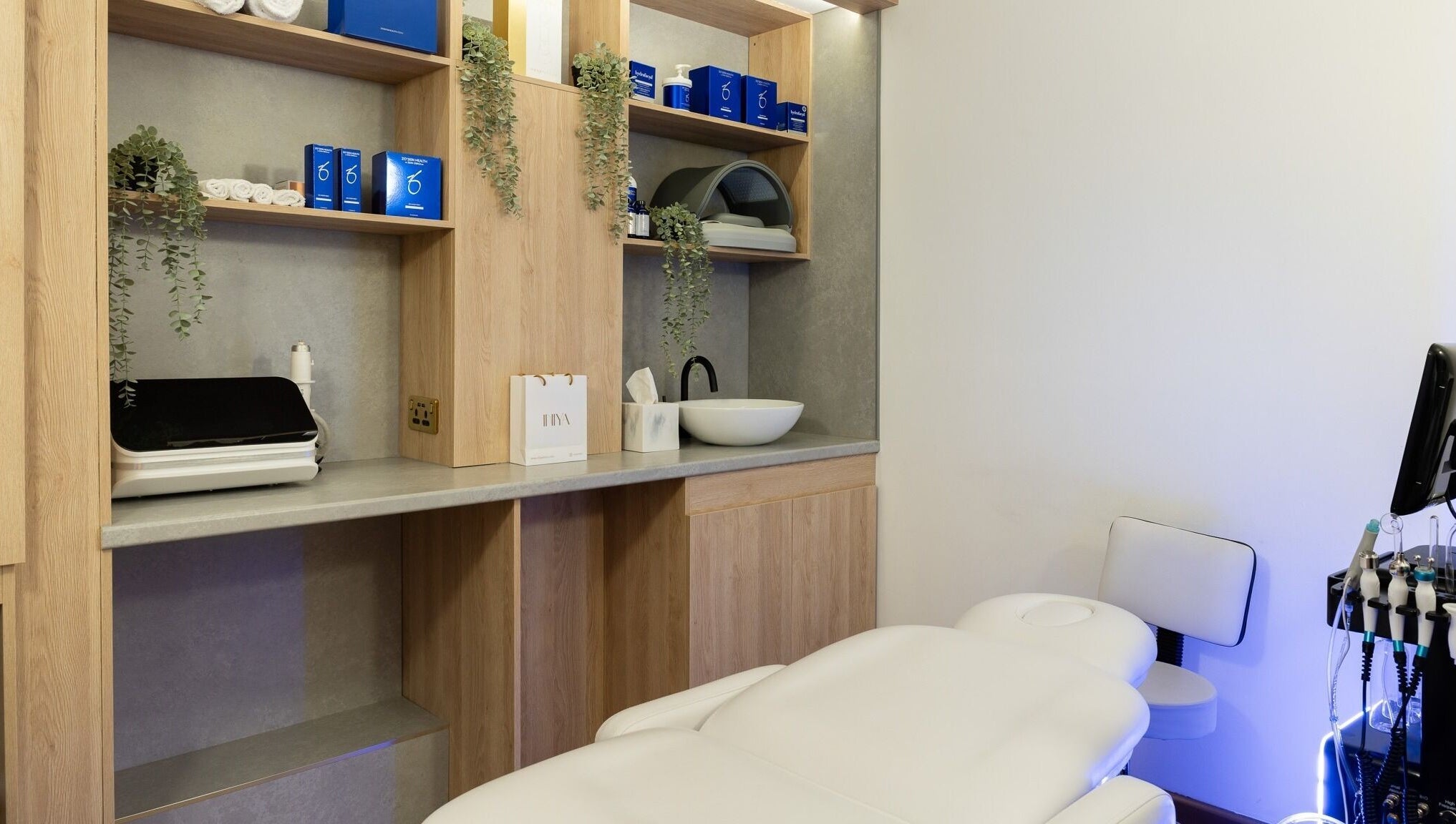 Modern treatment room at INIYA Aesthetics & Laser Clinic, Stanmore, England, GB, featuring sleek decor.