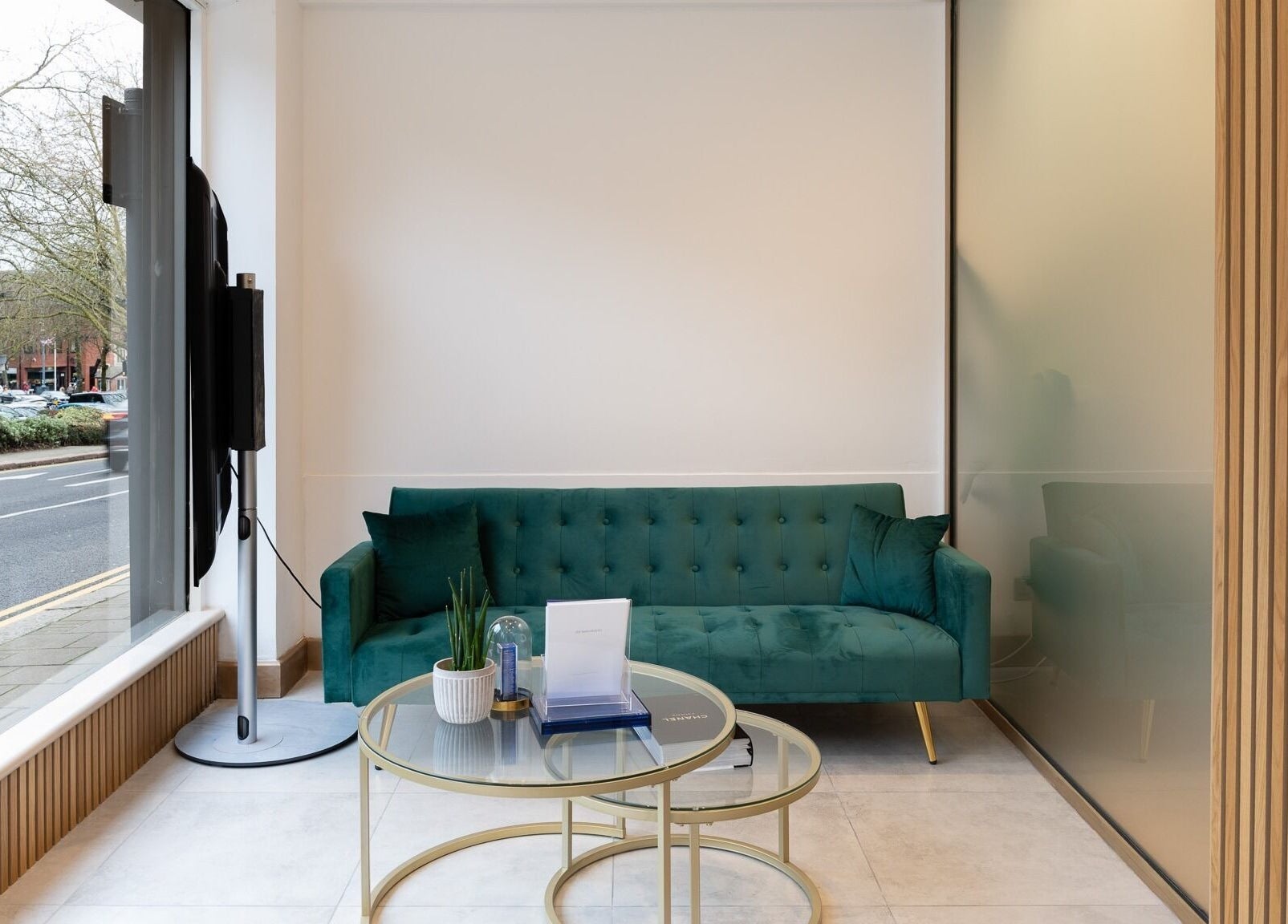 Calm seating area at INIYA Aesthetics & Laser Clinic, Stanmore, England, GB with a plush green sofa.