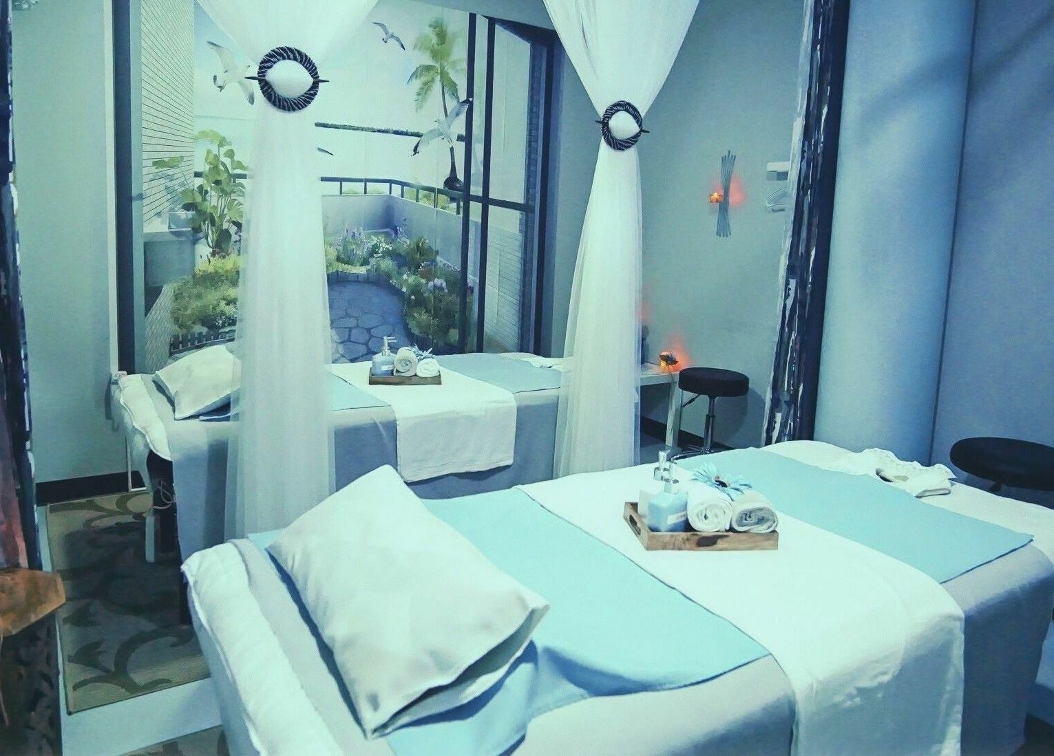 Luxurious massage room at Silver Sea Day Spa, San Jose, California, US featuring serene decor and plush treatment beds.