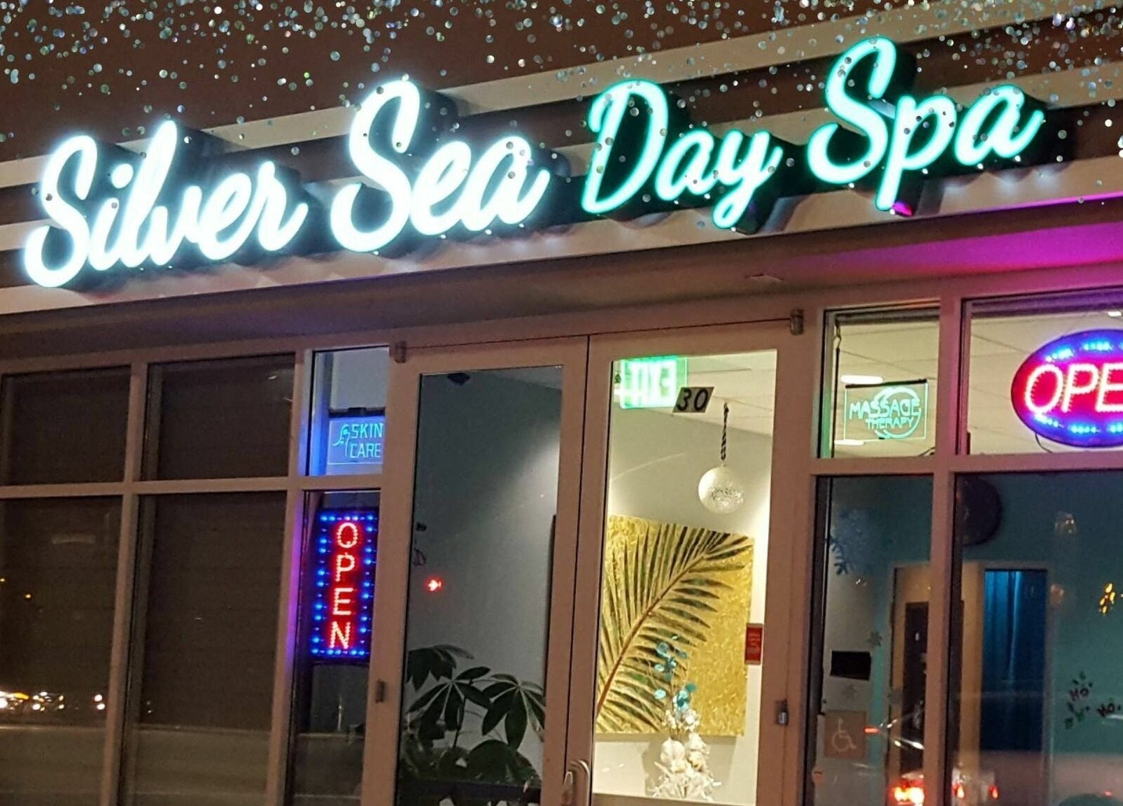 Entrance of Silver Sea Day Spa in San Jose, California, US with neon signs and welcoming decor.