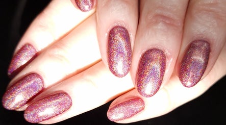 Glittering holographic nails at Inspired Nails, Northbourne, England, GB.