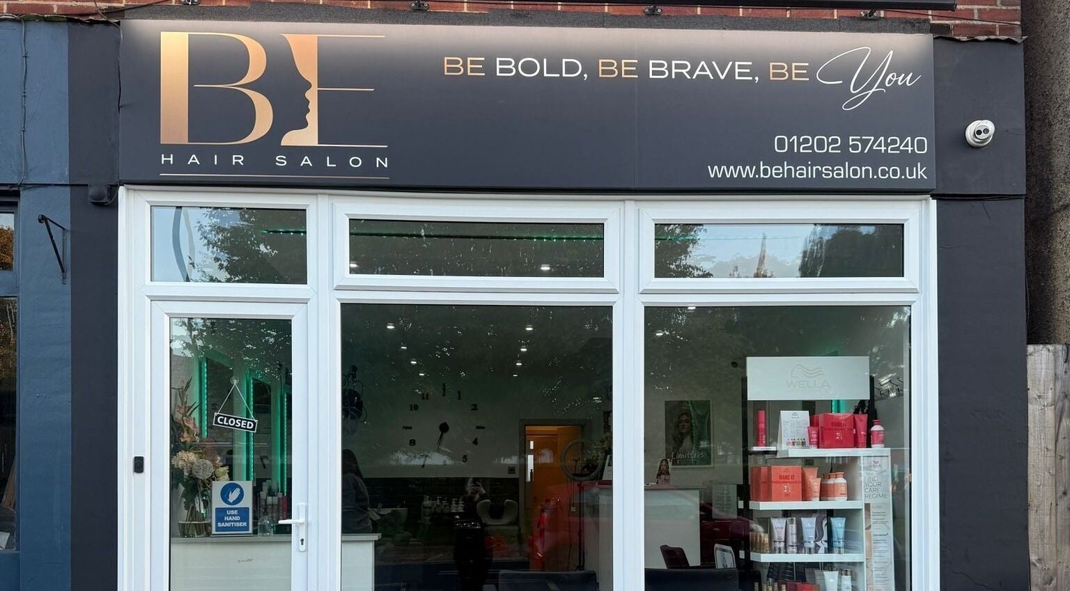 Entrance of Inspired Nails, Northbourne, England, GB with glass display and signage.