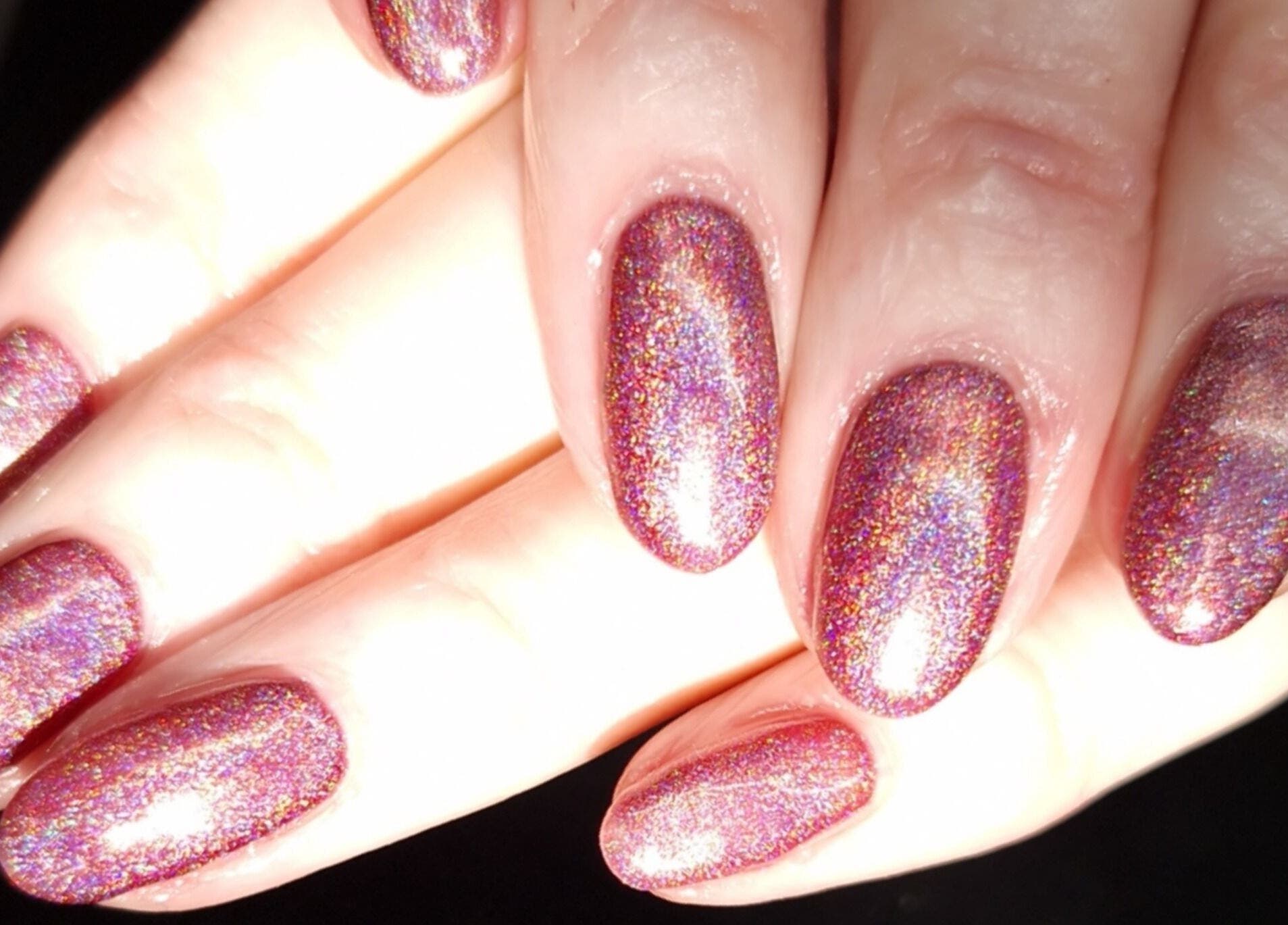 Sparkling holographic nails at Inspired Nails, Northbourne, England, GB, showcasing elegant nail artistry.