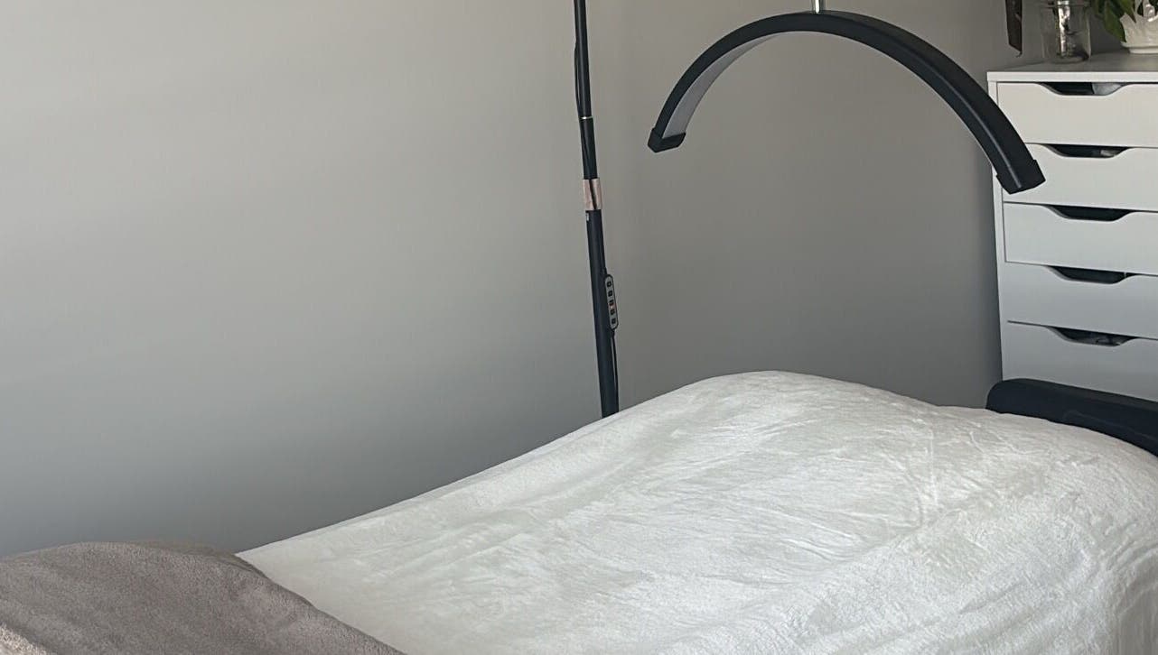 Comfortable treatment room at Wild Honey Lash Co in Calgary, Alberta, CA, featuring a plush bed and modern decor.