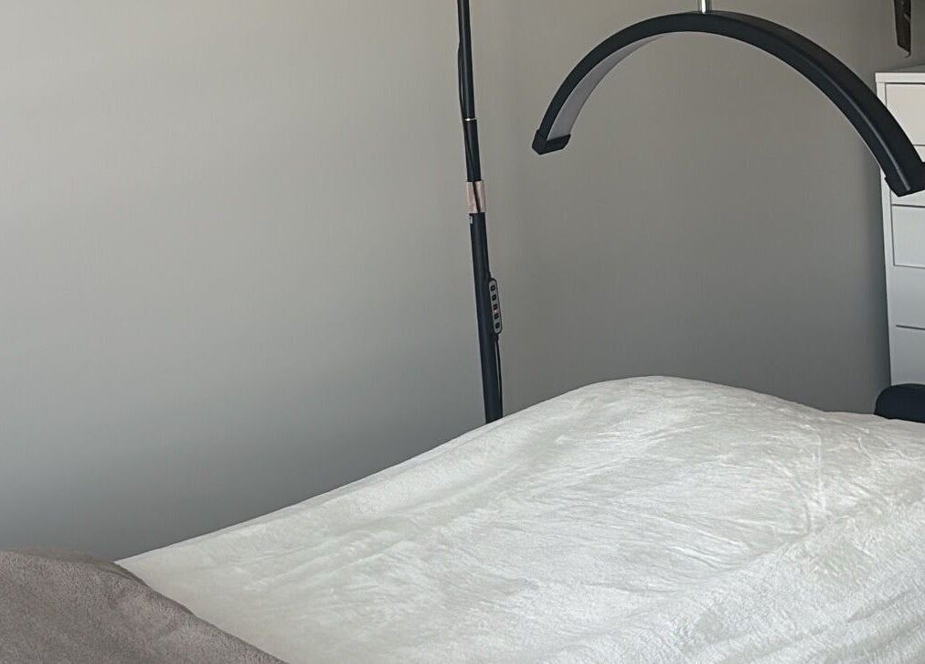 Comfortable treatment room at Wild Honey Lash Co in Calgary, Alberta, CA, featuring a plush bed and modern decor.