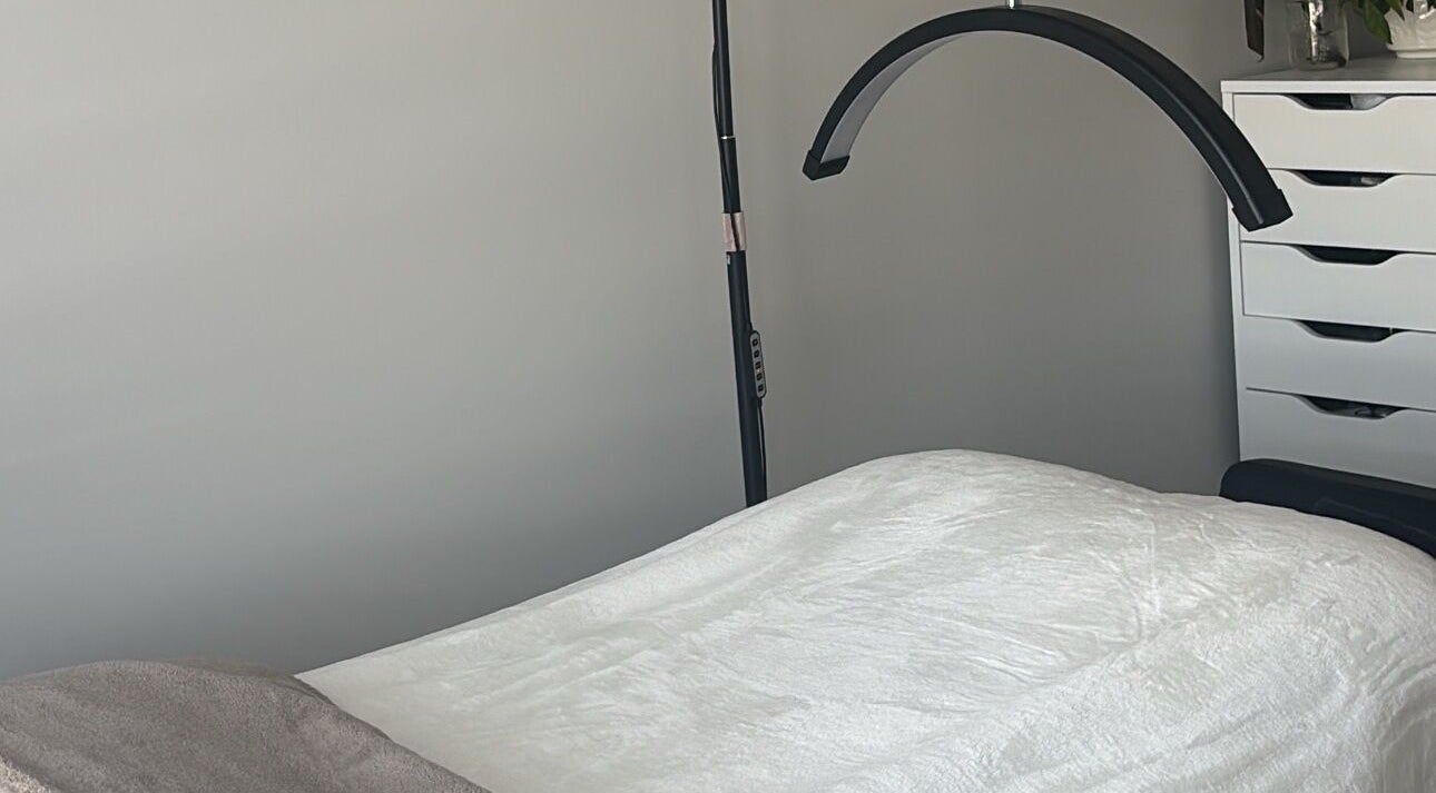 Comfortable treatment room at Wild Honey Lash Co in Calgary, Alberta, CA, featuring a plush bed and modern decor.
