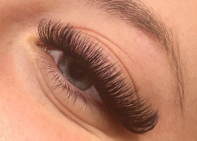 Close-up of eyelash extensions at Wild Honey Lash Co, Calgary, Alberta, CA, showcasing volume and precision.