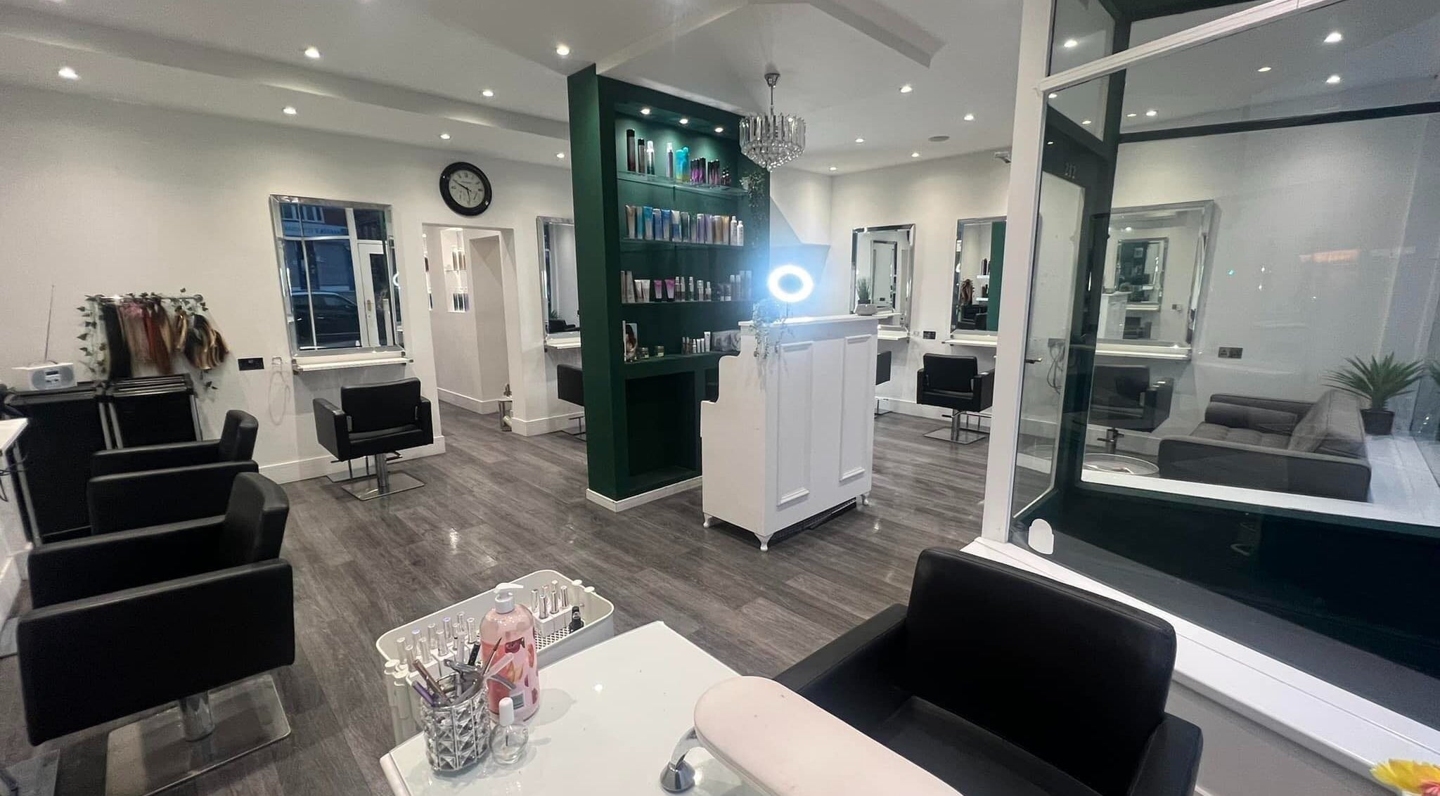Modern interior of C&Co Hairdressing in Portsmouth, England, GB, showcasing sleek styling stations and a bright atmosphere.