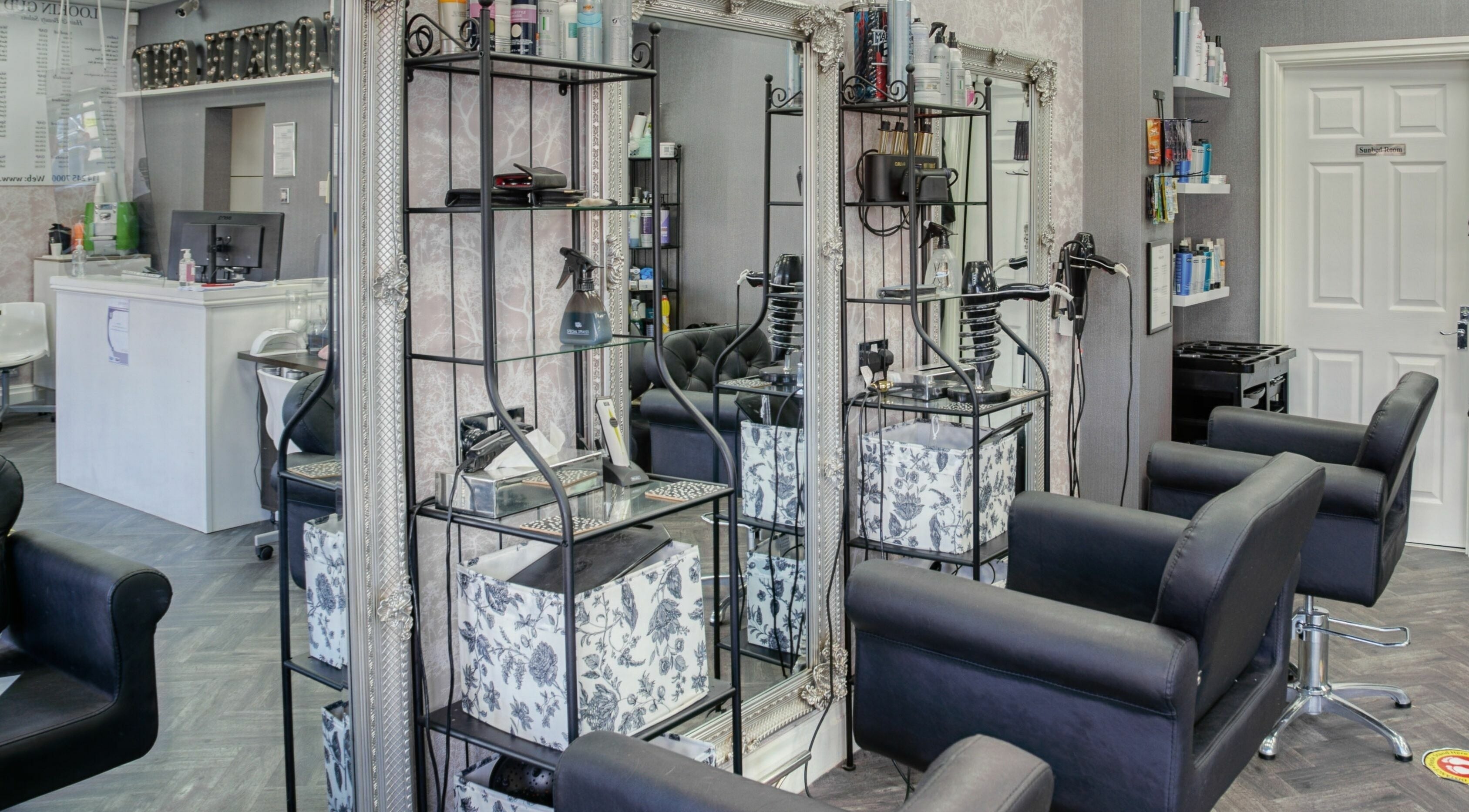 Chic interior of Lookin Gud Hair and Beauty Salons in Sheffield, England, GB, showcasing styling stations and decor.