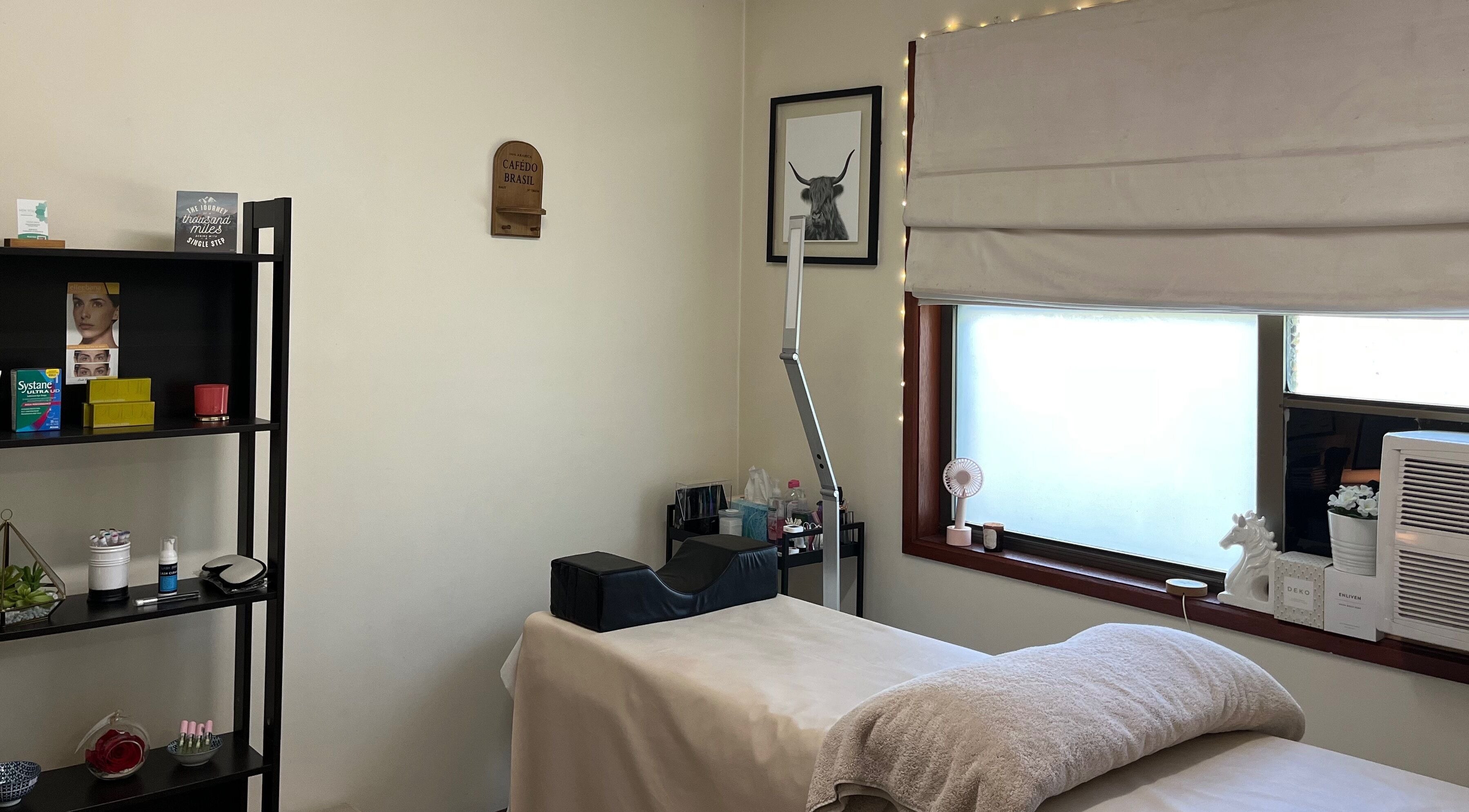Relaxing treatment room at New You Helensvale in Helensvale, Queensland, AU with a cozy bed and calming decor.
