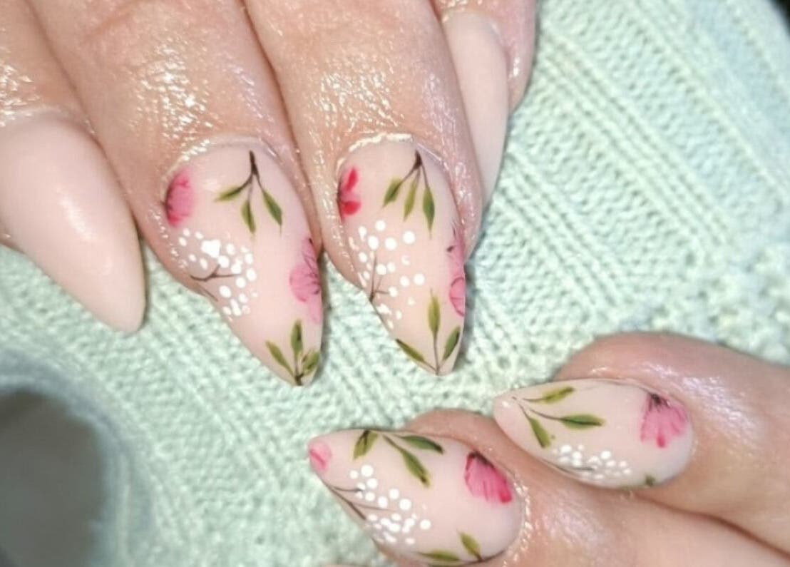 Floral nail art design at Beautiful New U, Boksburg, Gauteng, ZA. Elegant and detailed pink and green patterns.