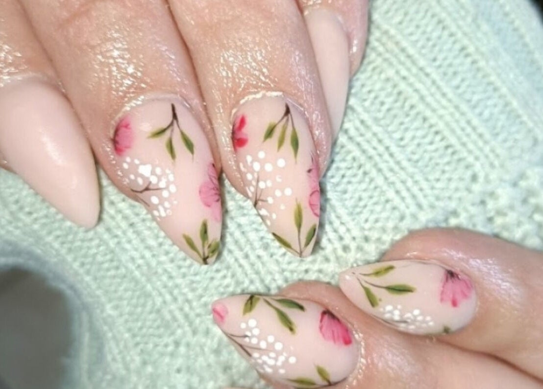 Elegant floral nail art at Beautiful New U in Boksburg, Gauteng, ZA. Perfectly manicured hands display intricate designs.
