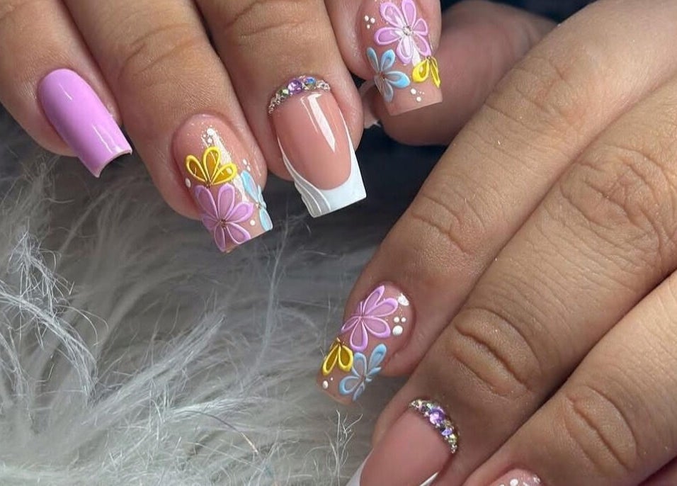 Vibrant floral nail art at Belle Ame Beauty and Nails, Millwater, Auckland, NZ, showcasing colorful intricate designs.