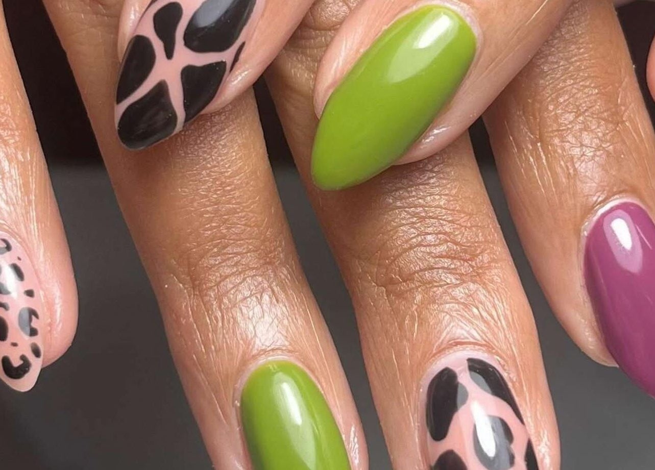 Stylish nail art at Belle Ame Beauty and Nails, Millwater, Auckland, NZ featuring leopard and vibrant colors.