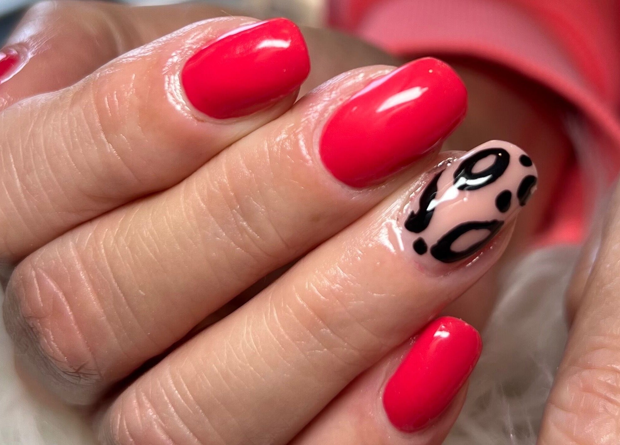 Vibrant red nails with stylish designs at Belle Ame Beauty and Nails, Millwater, Auckland, NZ.