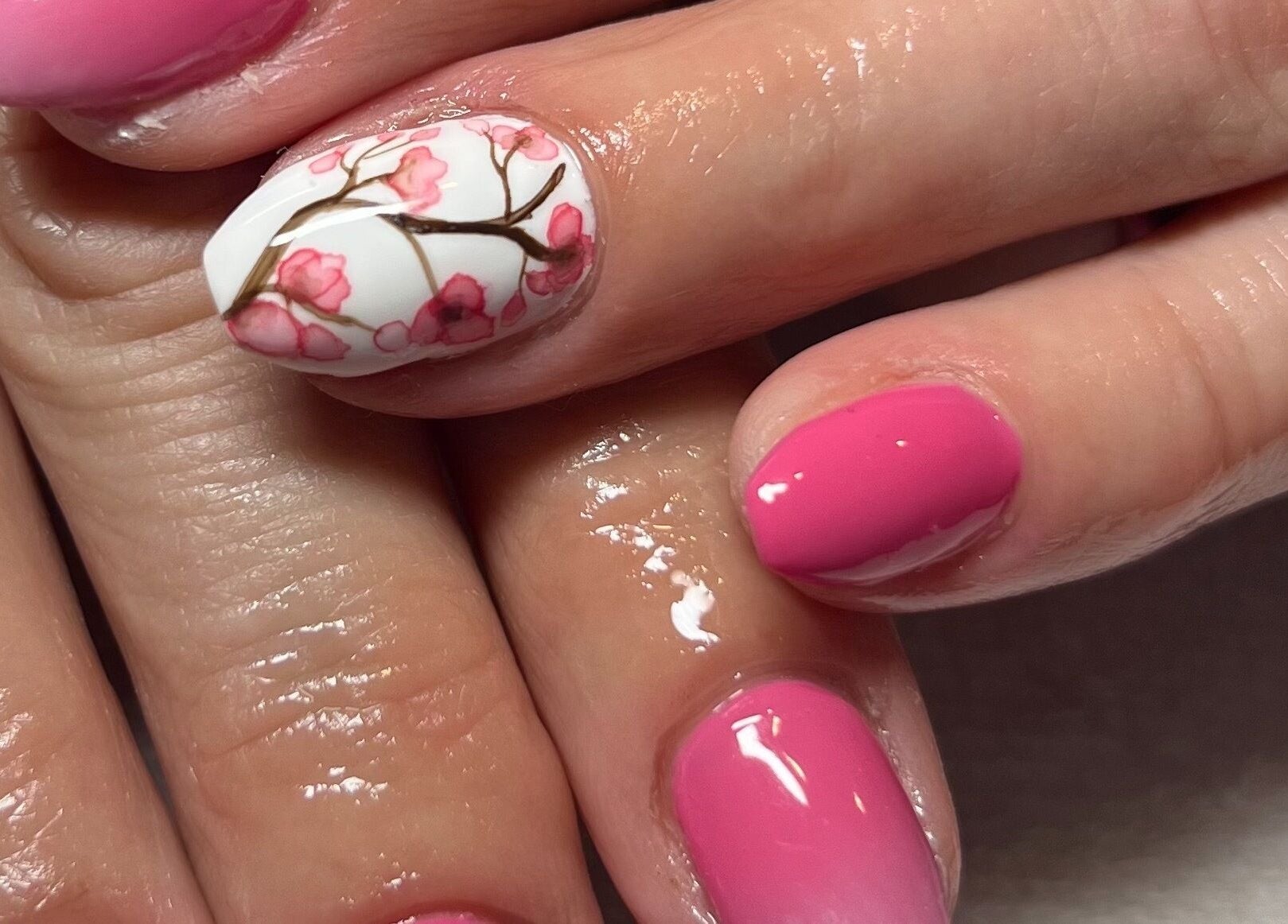 Cherry blossom nail art at Belle Ame Beauty and Nails, Millwater, Auckland, NZ. Pink and white floral design.