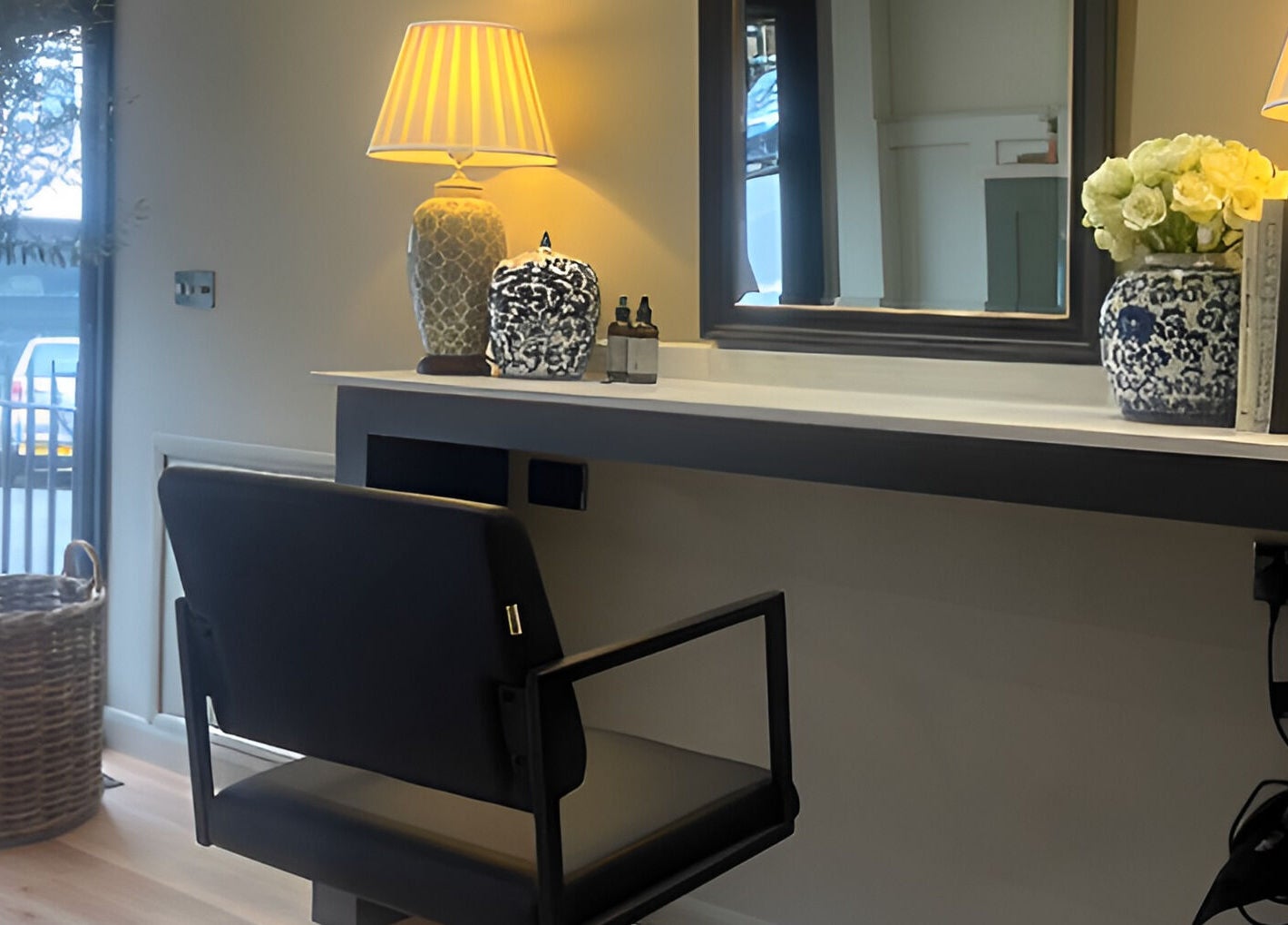 Elegant salon interior at Adam James Oxted on Oxted High Street, England, GB with modern decor and natural lighting.