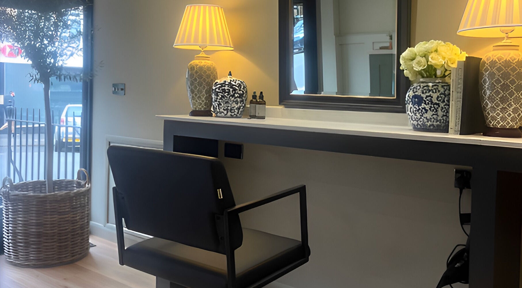 Elegant salon interior at Adam James Oxted on Oxted High Street, England, GB with modern decor and natural lighting.