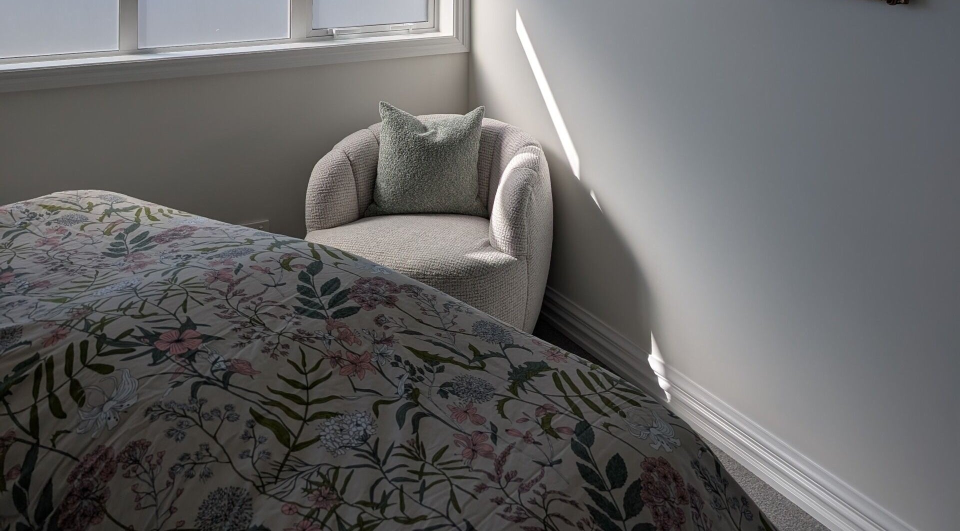 Serene bedroom at My Beauty Treat, Rangiora, Canterbury Region, NZ, featuring a floral bedspread and armchair.
