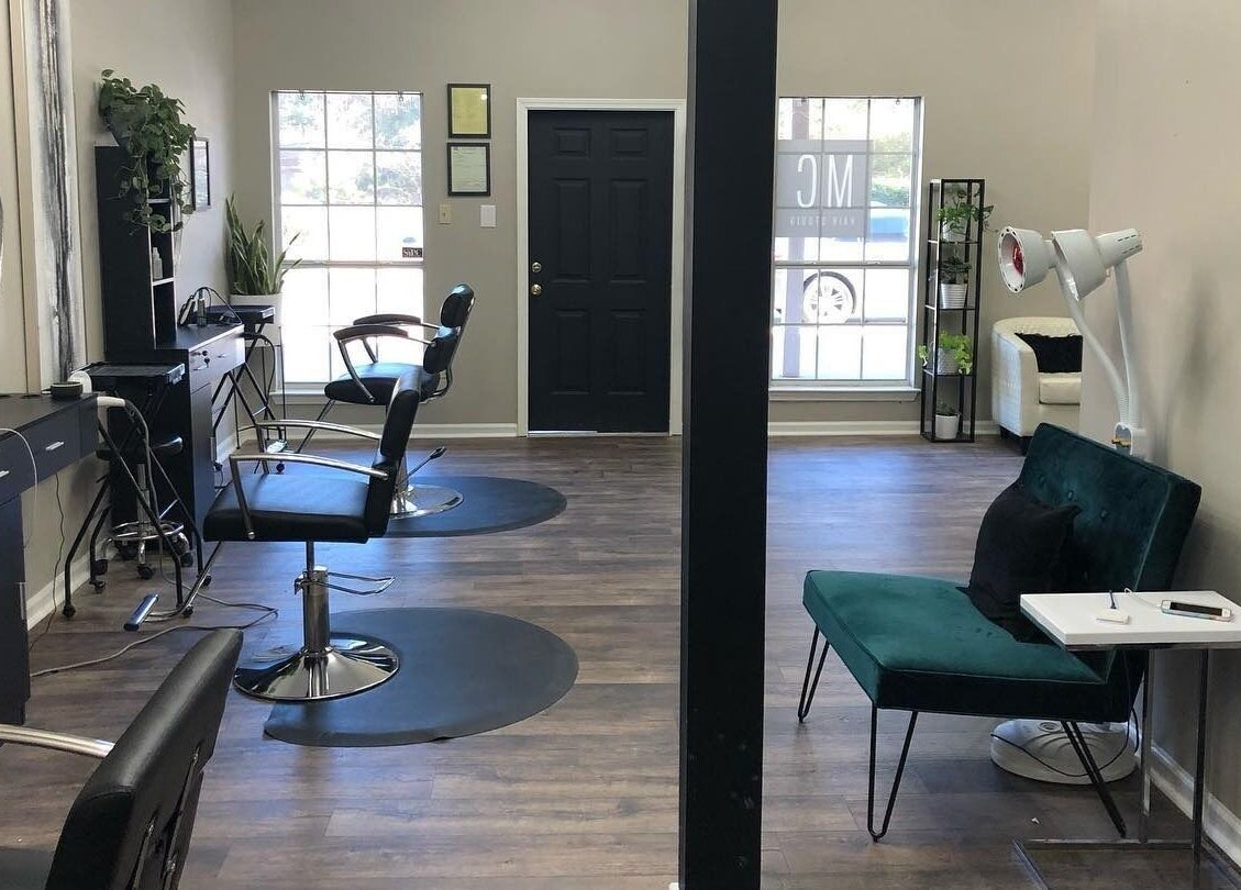 Modern interior of MC Hair Studio in Little Rock, Arkansas, US with styling chairs and elegant decor.